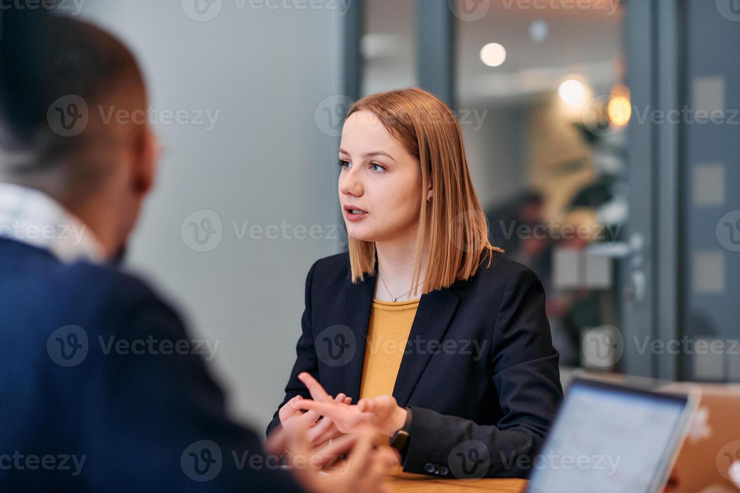 Businesswoman Leading Discussion in Modern Office Setting photo