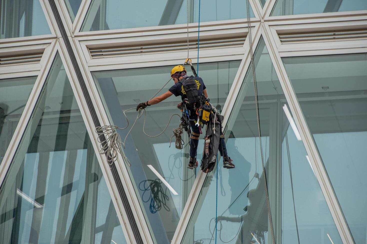 Italy 2024 A rope operator with a harness, lowering himself onto the facade of a building photo