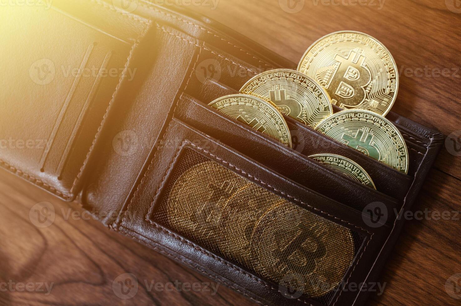 Group of Bitcoin token in leather wallet. Bitcoin is one of the popular cryptocurrency, a virtual currency or a digital currency. photo