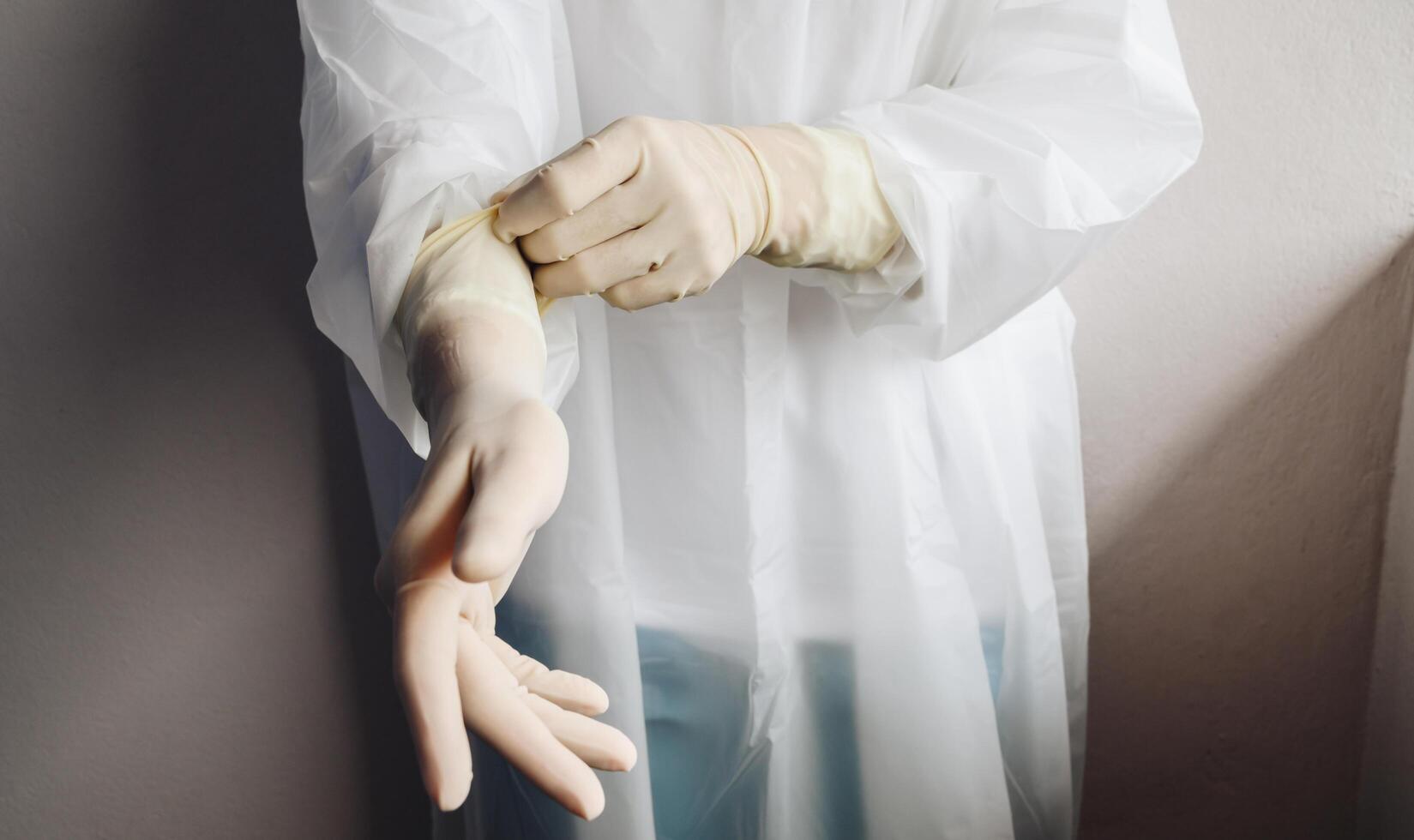 Cropped shot of healthcare worker wearing PPE suit for working in hospital during Covid-19 pandemic. PPE is equipment that will protect the user against health or safety risks at work. photo