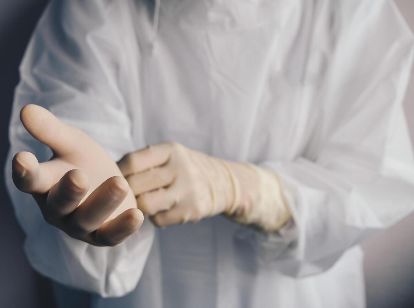 Cropped shot of healthcare worker wearing PPE suit for working in hospital during Covid-19 pandemic. PPE is equipment that will protect the user against health or safety risks at work. photo