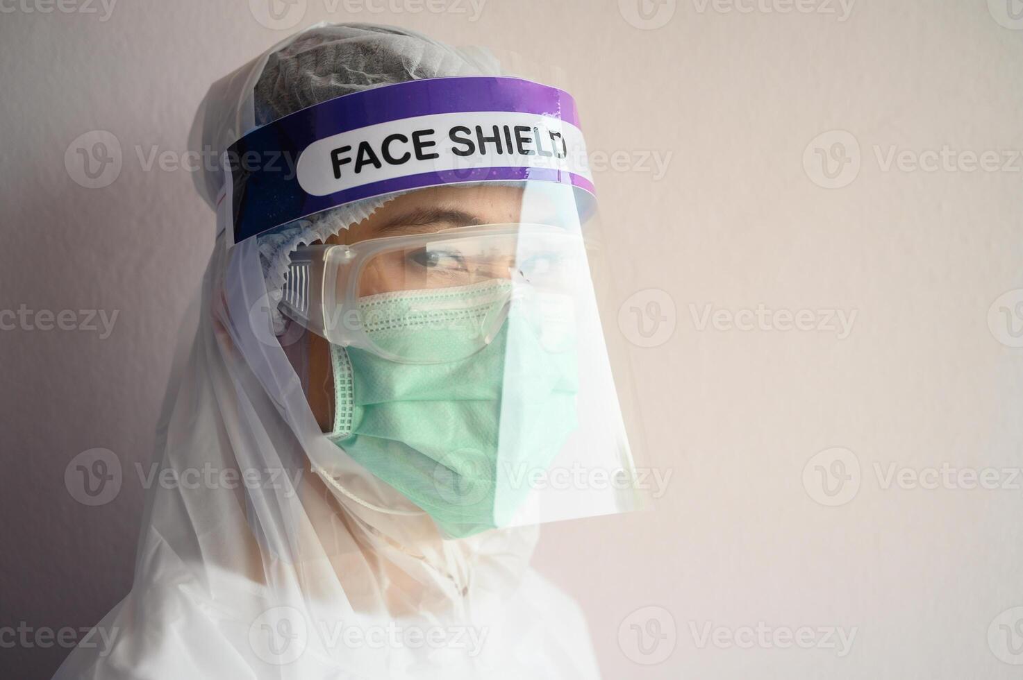 Nurse wearing PPE suit, Face shield and surgical mask for protect coronavirus disease. PPE while protecting healthcare workers from exposure to the COVID-19 virus in healthcare settings. photo