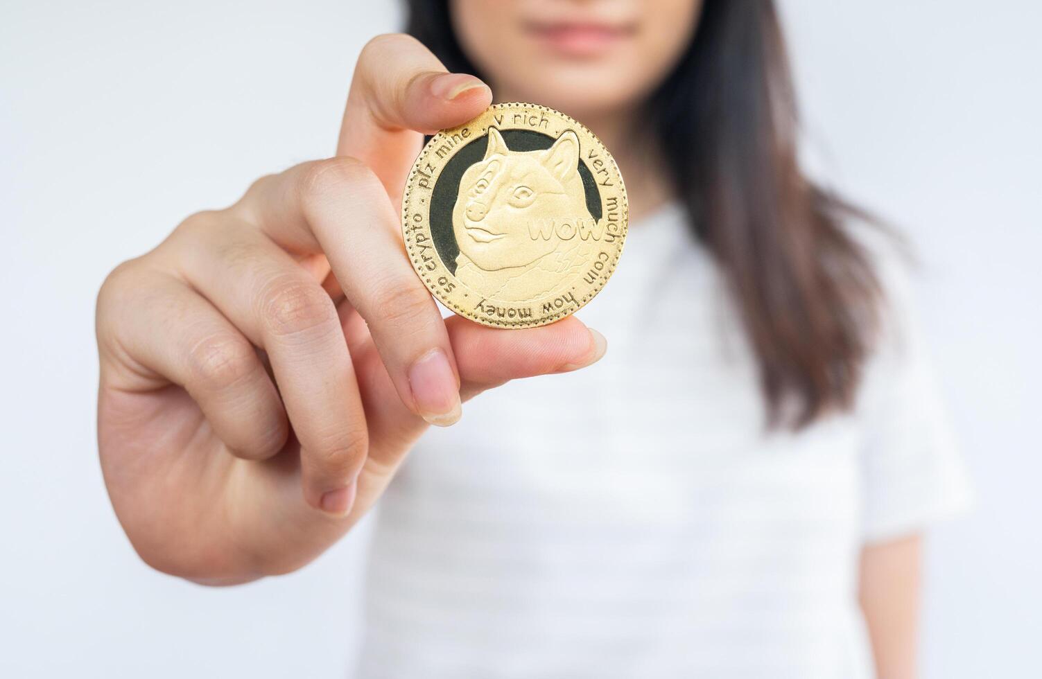 Woman holding a Dogecoin tokens. photo