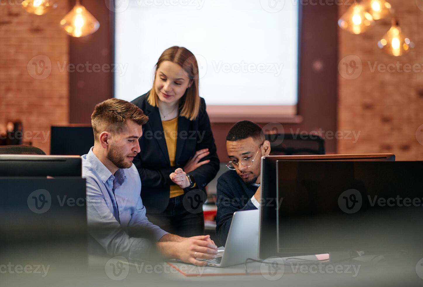 Strategic Business Meeting. Group of Professionals Collaborating in Office Using Computers photo