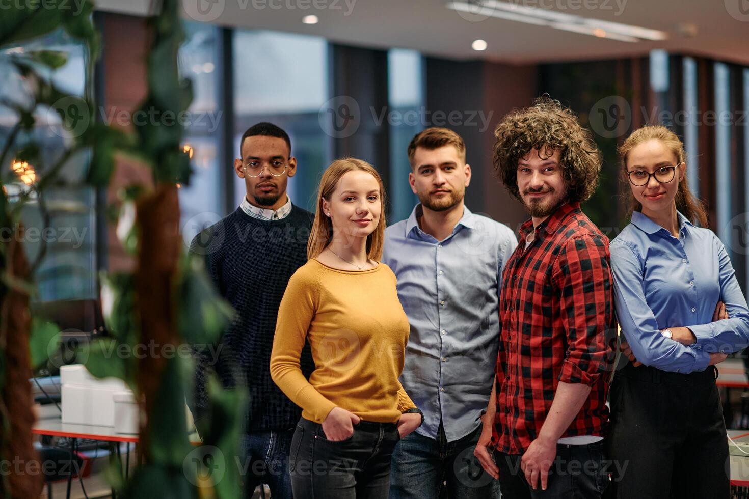 Portrait of successful creative business team looking at camera and smiling. Diverse business people standing together at startup. Selective focus photo