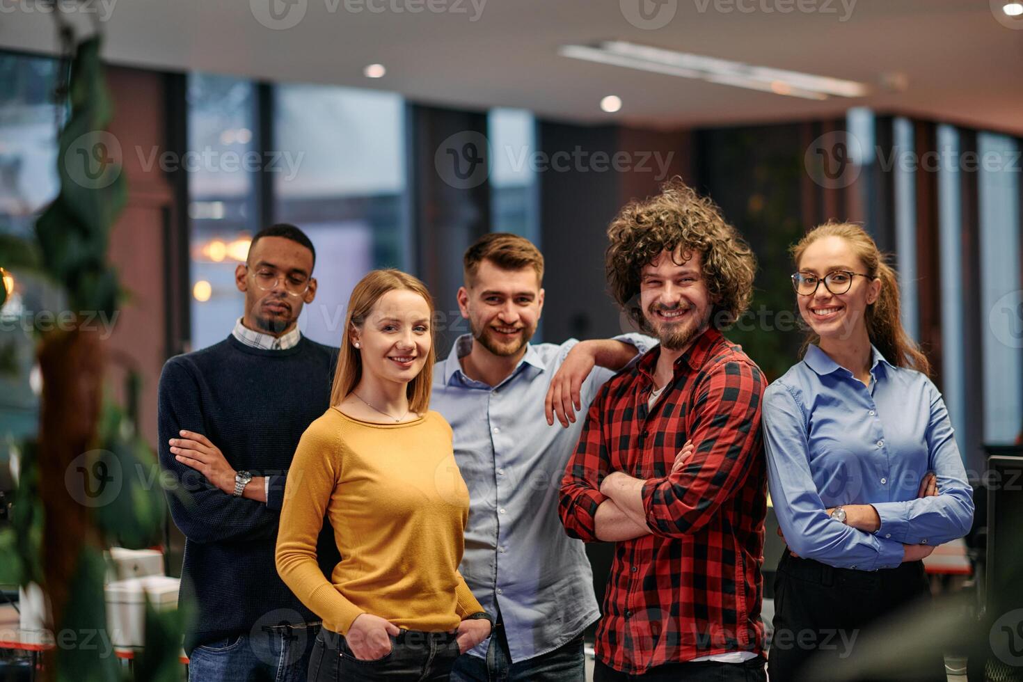 Portrait of successful creative business team looking at camera and smiling. Diverse business people standing together at startup. Selective focus photo