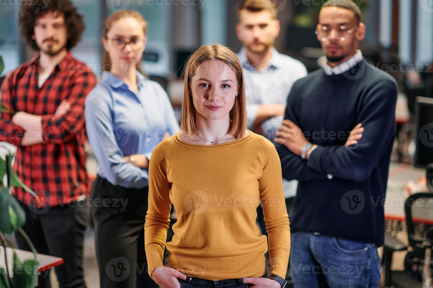 Portrait of successful creative business team looking at camera and smiling. Diverse business people standing together at startup. Selective focus photo
