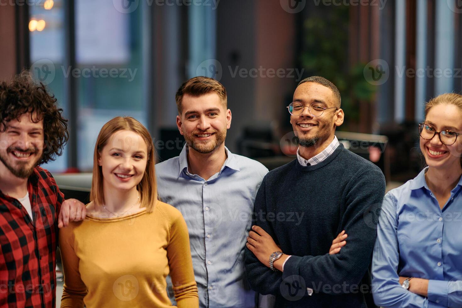 Portrait of successful creative business team looking at camera and smiling. Diverse business people standing together at startup. Selective focus photo