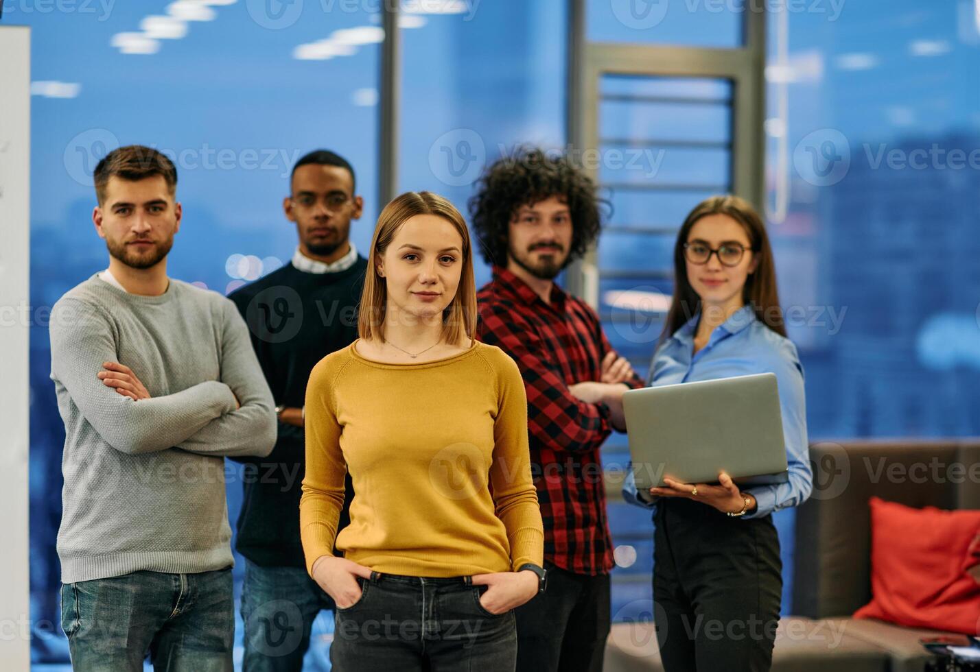 Portrait of successful creative business team looking at camera and smiling. Diverse business people standing together at startup. Selective focus photo