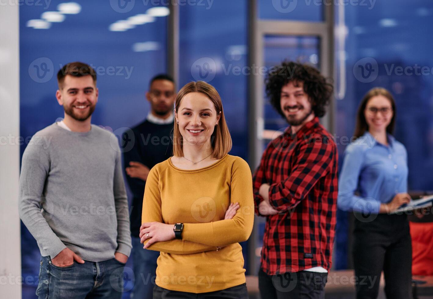 Portrait of successful creative business team looking at camera and smiling. Diverse business people standing together at startup. Selective focus photo