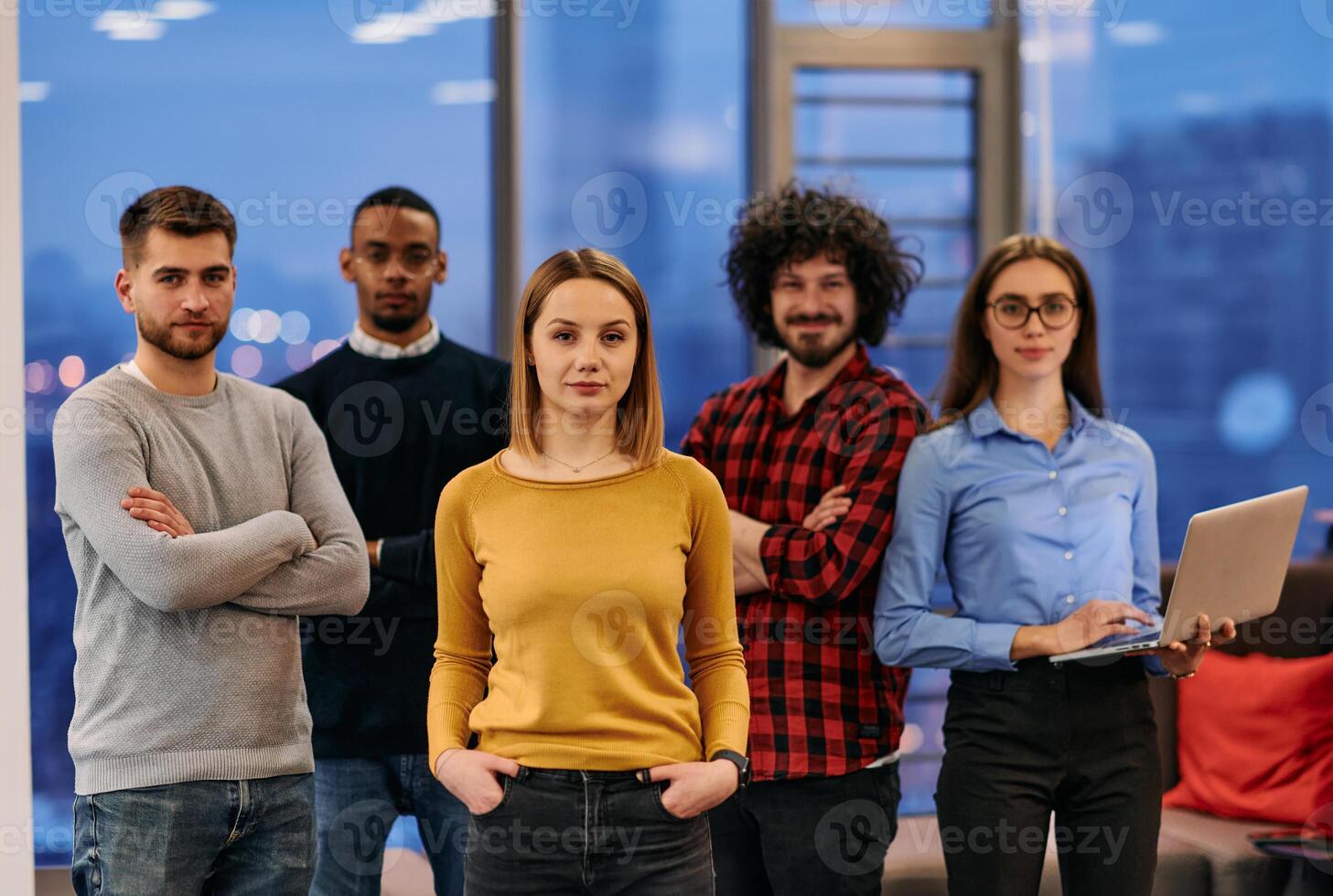 Portrait of successful creative business team looking at camera and smiling. Diverse business people standing together at startup. Selective focus photo
