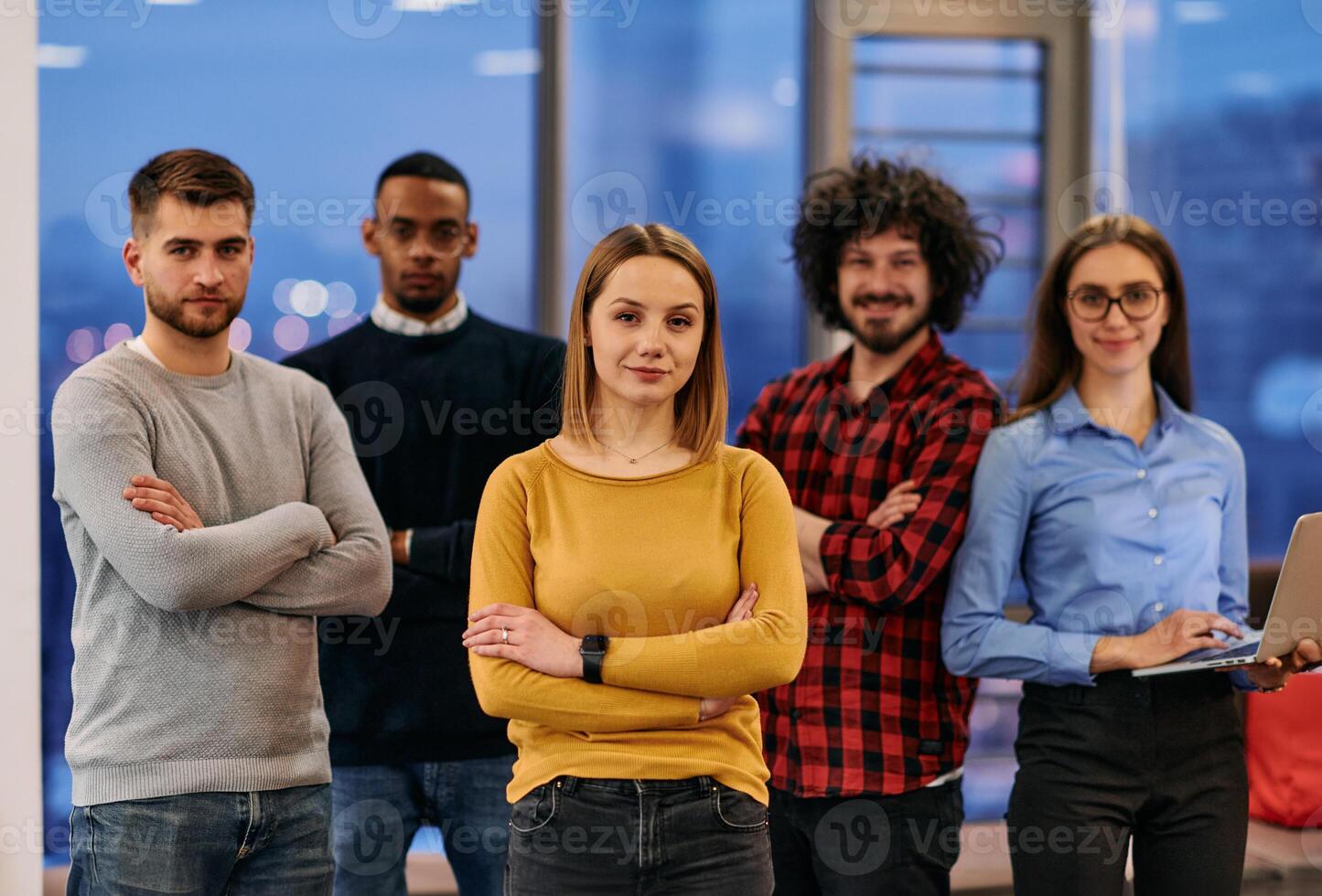 Portrait of successful creative business team looking at camera and smiling. Diverse business people standing together at startup. Selective focus photo