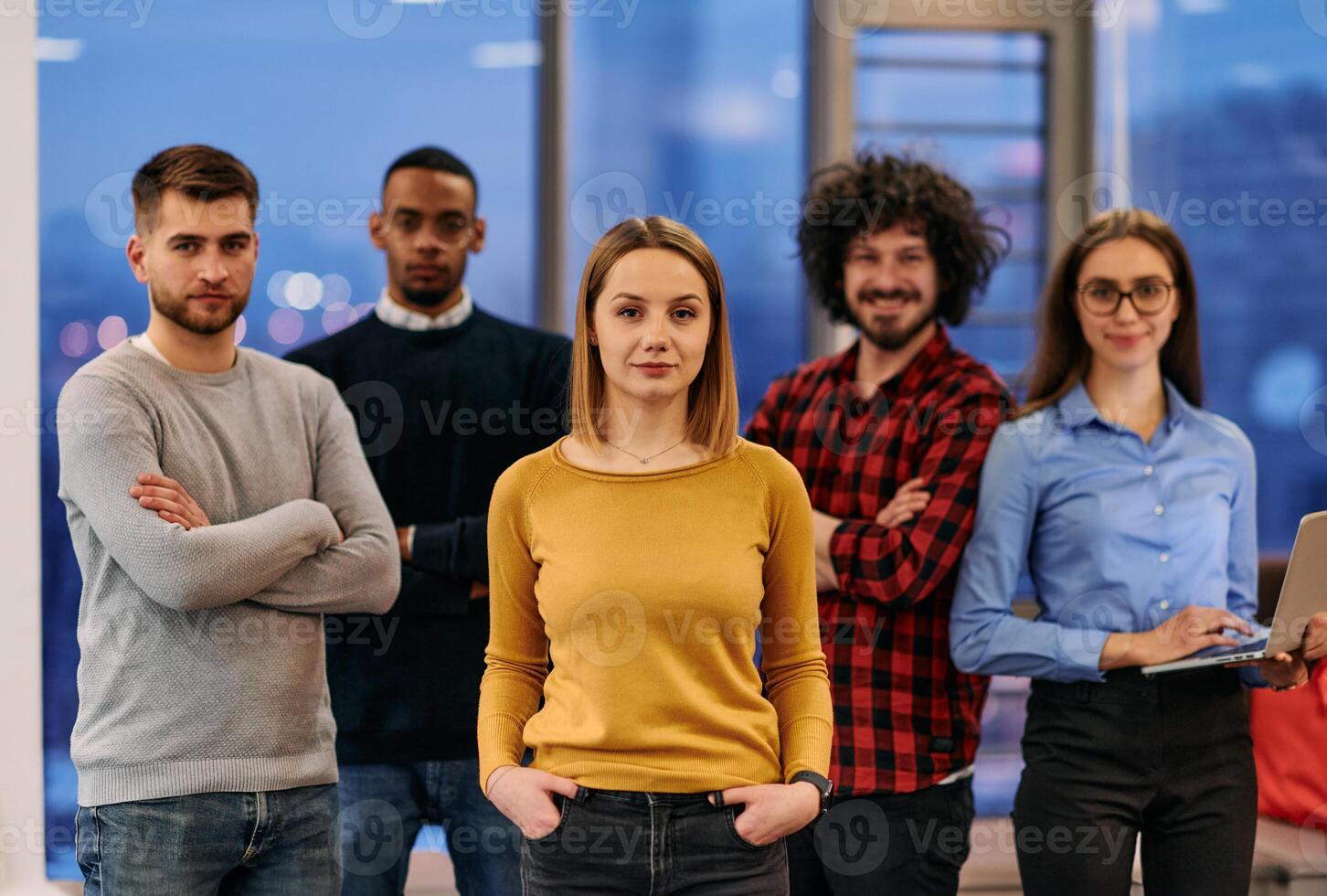 Portrait of successful creative business team looking at camera and smiling. Diverse business people standing together at startup. Selective focus photo