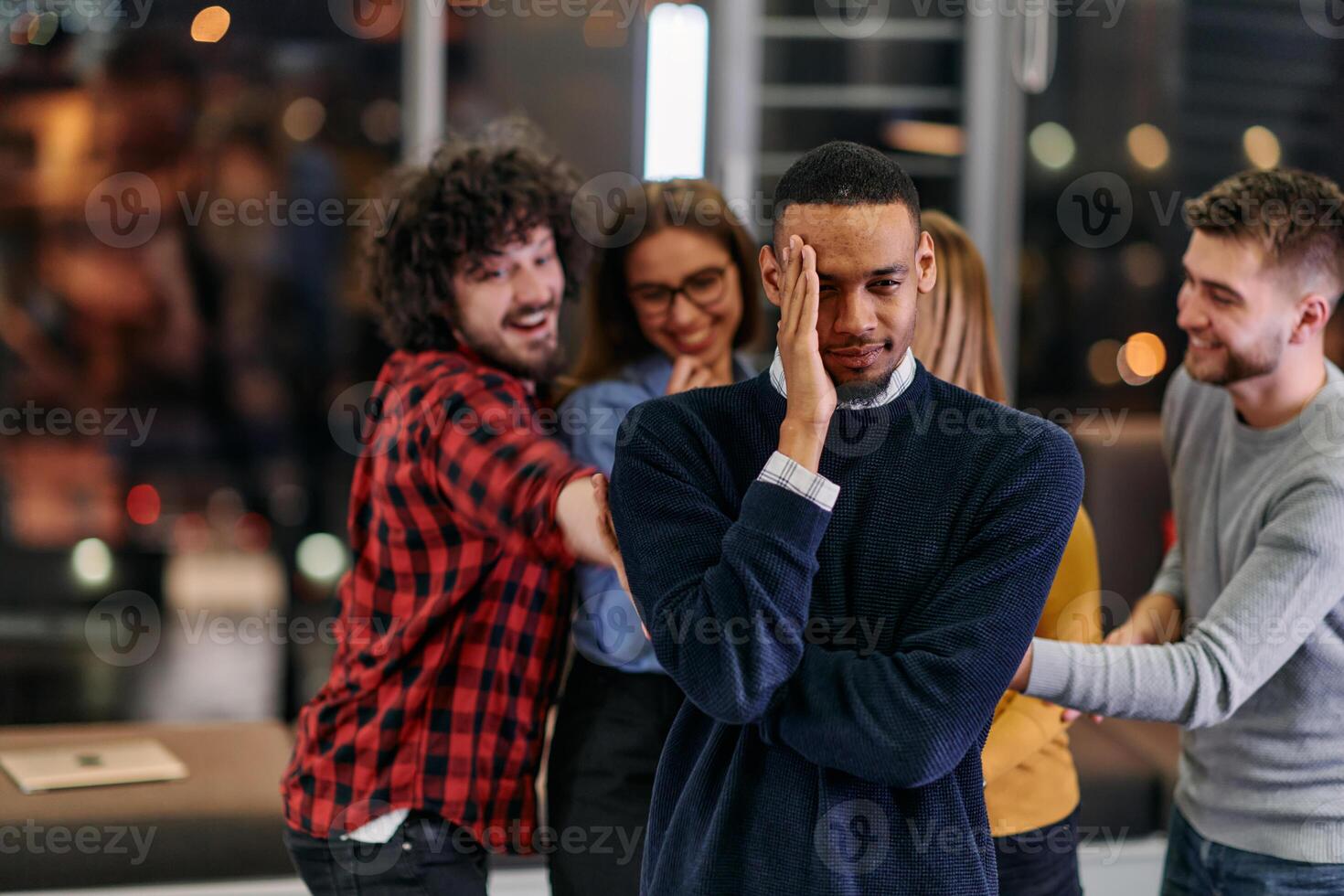 A group of young business people have fun playing interesting games while taking a break from work in a modern office. Selective focus photo