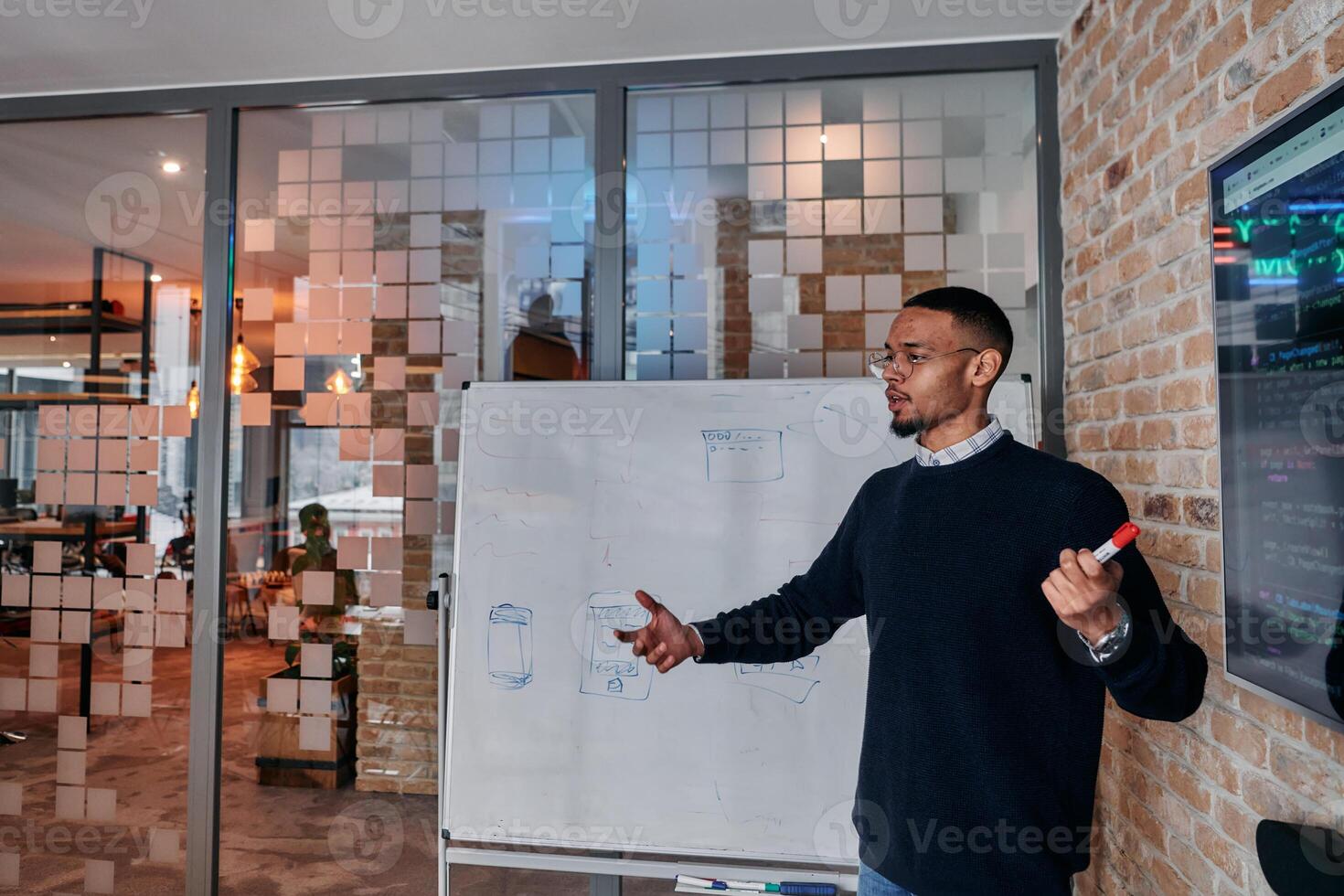 African American businessman delivers a compelling presentation of his business strategy to his colleagues, fostering collaboration and forward thinking photo