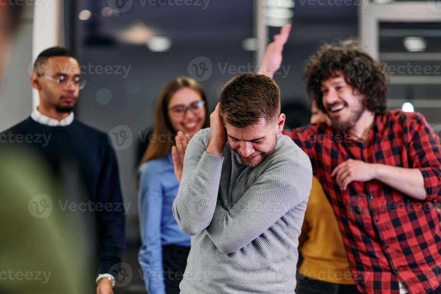 A group of young business people have fun playing interesting games while taking a break from work in a modern office. Selective focus photo