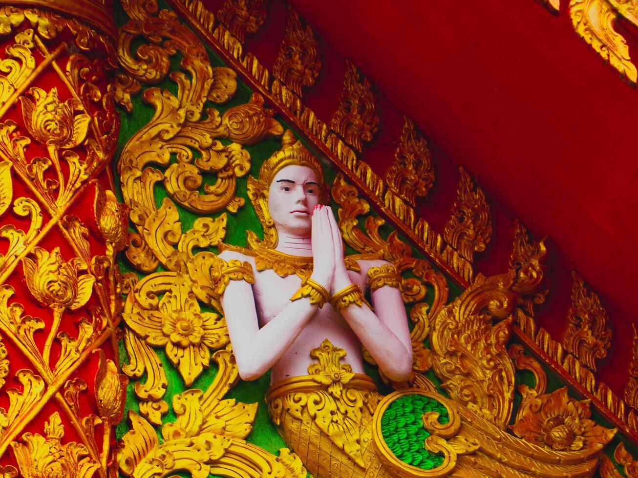 Beautiful sculptures at Sapan Temple in the middle of a valley surrounded by nature in Nan Province, Thailand. photo