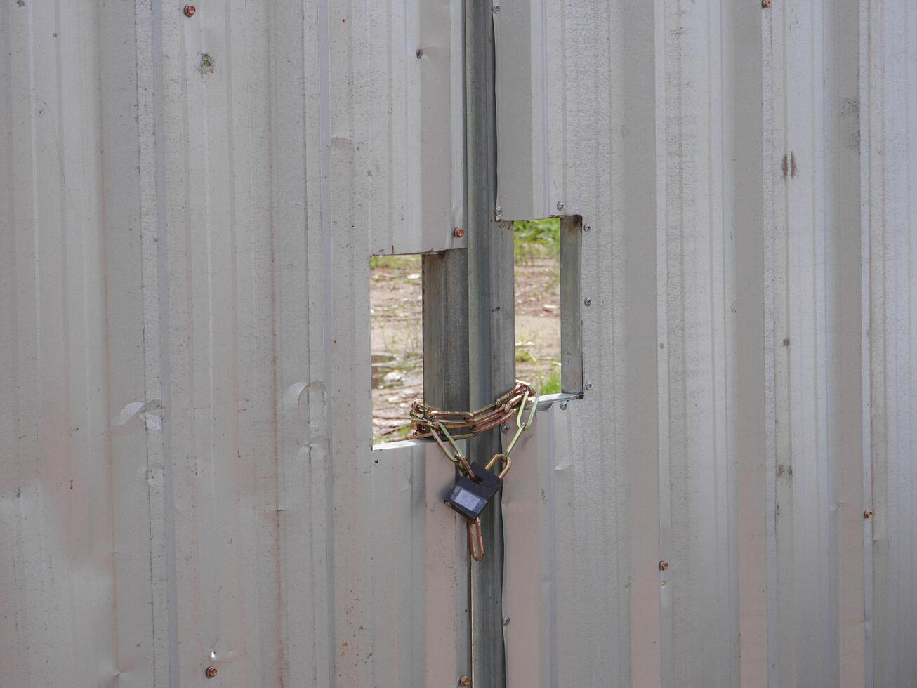 Locked Gate with Padlock and Chains photo