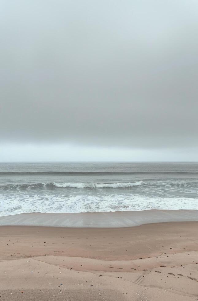 Coastal Scene With Waves Crashing on Sandy Beach Under a Cloudy Sky photo