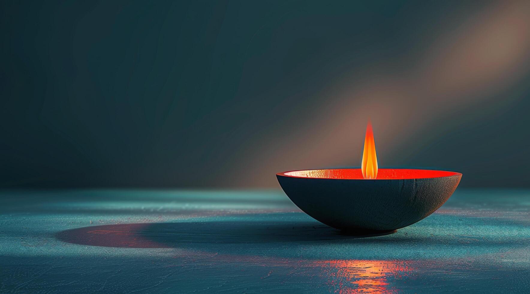 A Single Lit Candle in a Blue Setting photo