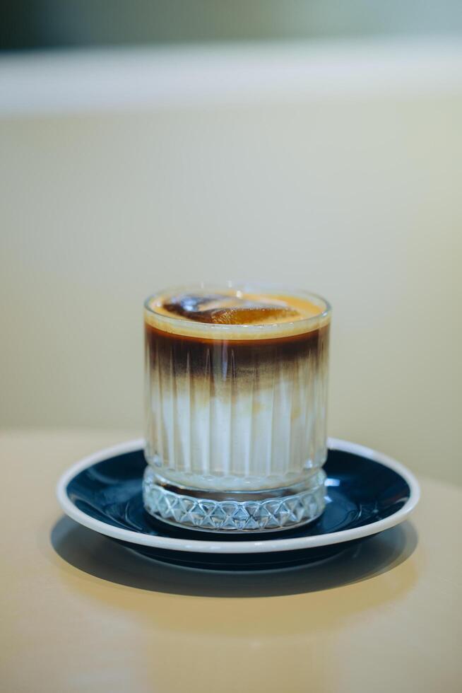 Elegant layered coffee in a clear glass, highlighting rich textures. photo