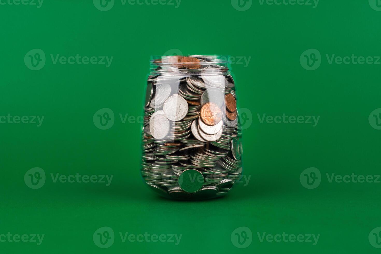 Saving coins in a glass jar creates a good financial and investment asset. Financial growth and investment returns photo