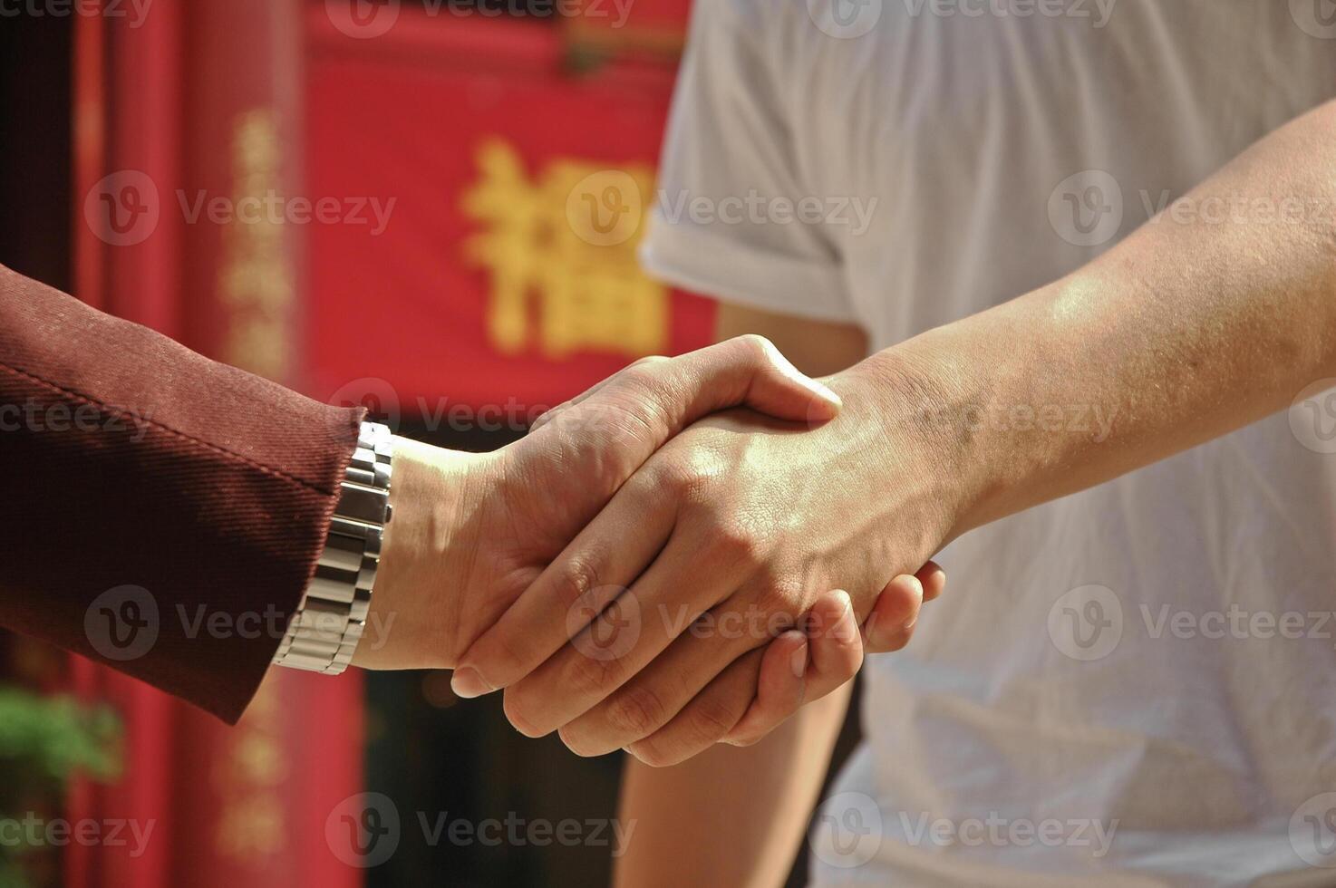 agreement reached by hands shaking between the rich and the poor photo