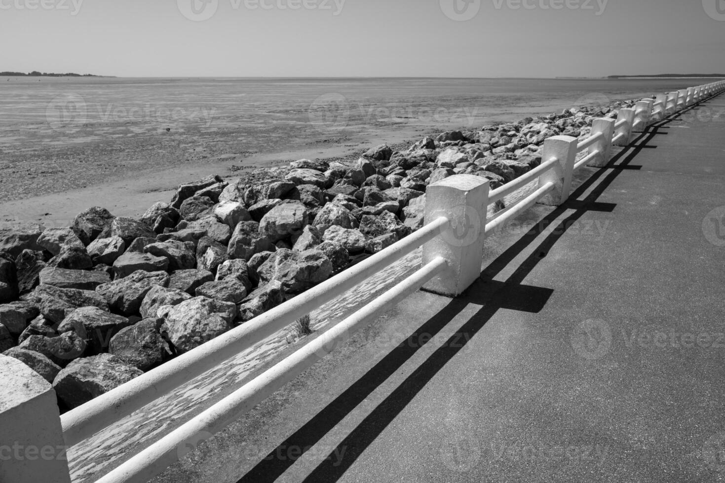 white railing on the coast road Le Crotoy North France, greyscale shot photo