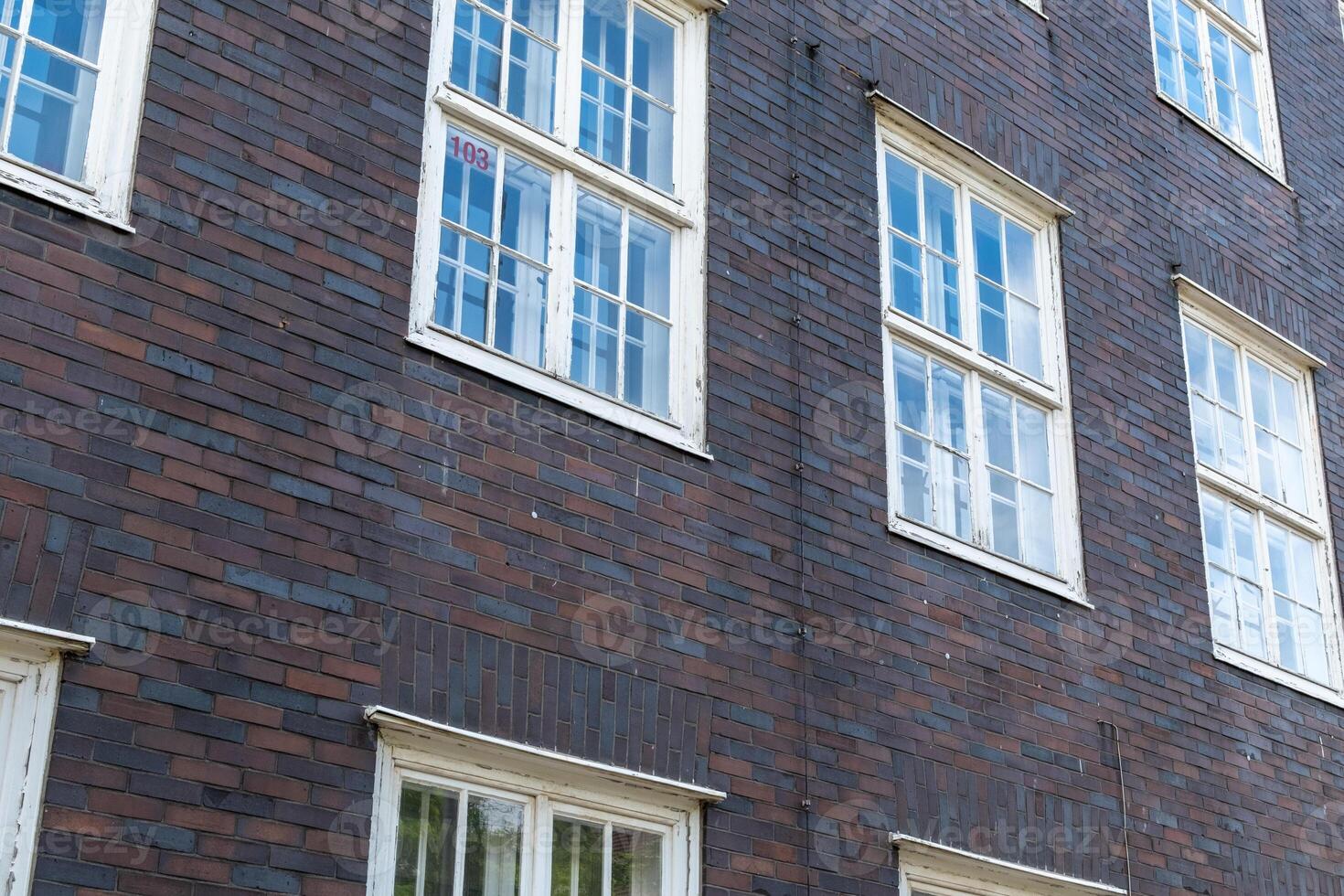 brick house wall with even windows photo
