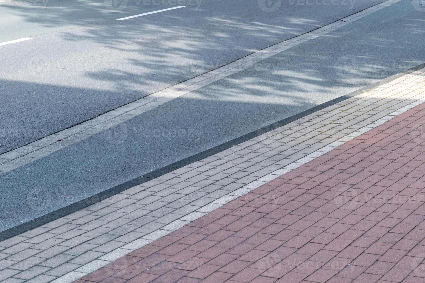 empty street with empty sidewalk photo