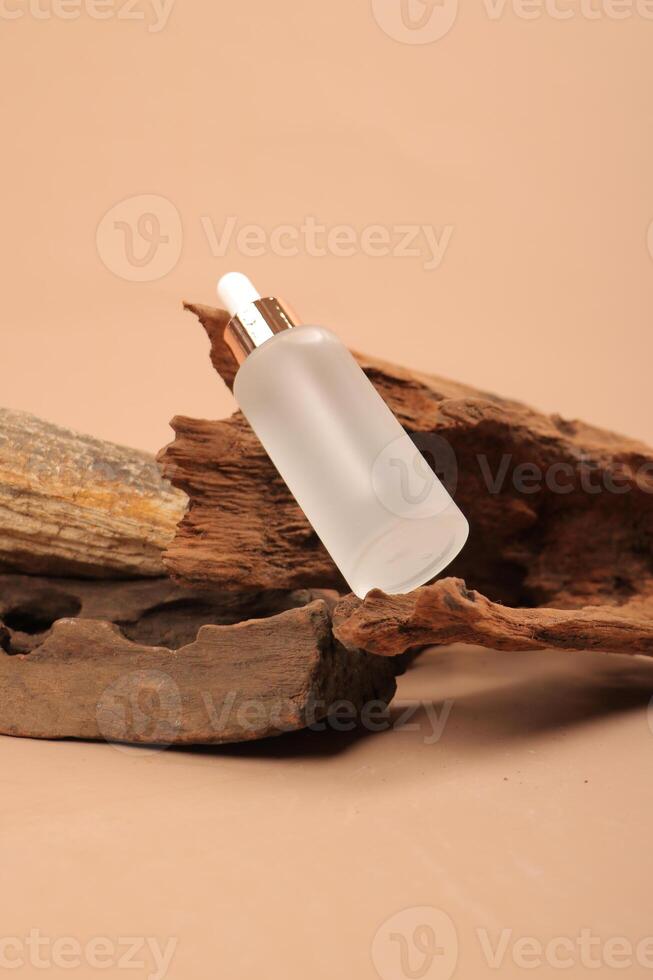 Elegant Frosted Glass Dropper Bottle on Rustic Wooden Background photo