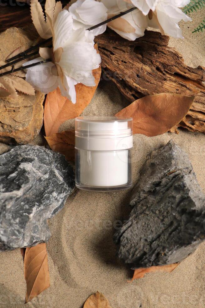 Elegant White Jar with Natural Elements on Sandy Background photo