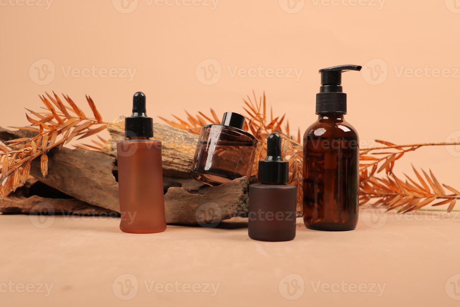 Rustic Amber Glass Dropper Bottles and Pump Dispenser on Natural Background for Organic Skincare photo