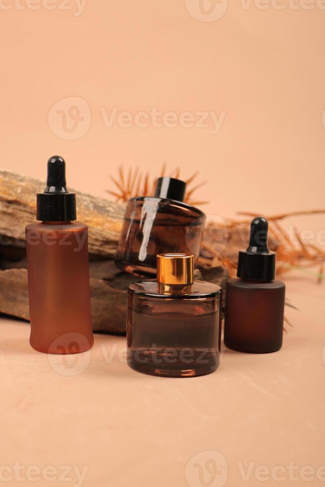 Elegant Amber Glass Dropper Bottles and Containers on Rustic Wood Background for Organic Skincare photo