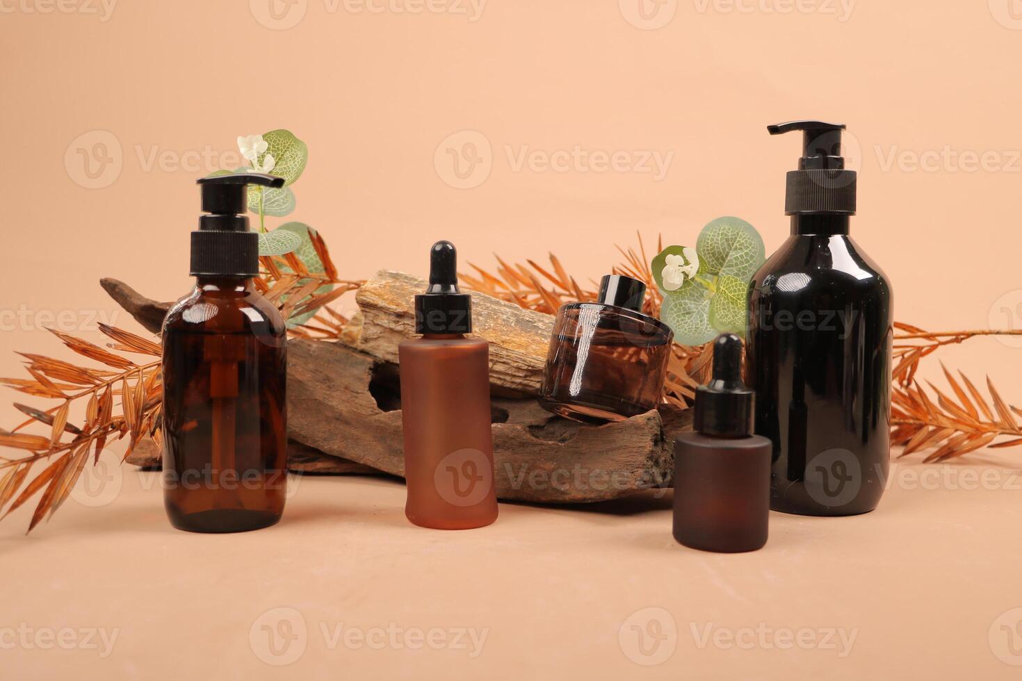 Elegant Amber Glass Dropper Bottles and Pump Dispenser for Organic Skincare Products on Rustic Background photo
