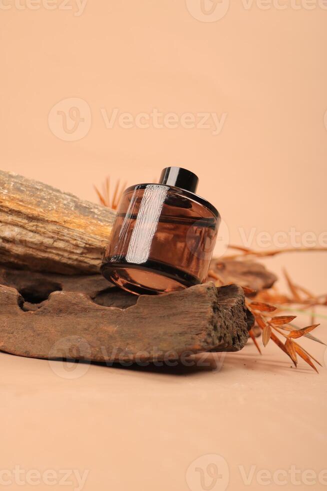 Amber Glass Bottle on Rustic Wood Background for Organic Skincare and Essential Oils photo