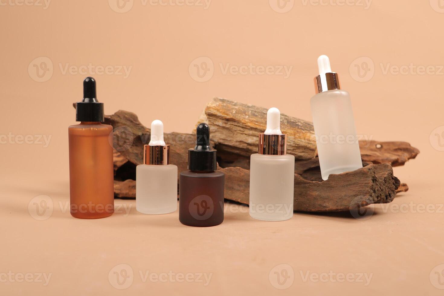Diverse Glass Dropper Bottles for Skincare and Essential Oils on Rustic Background photo