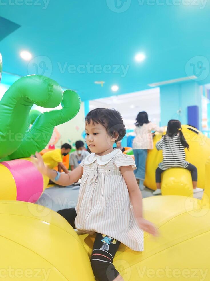 Positive activities for children playing in an indoor area filled with toy facilities and a place where they can find unlimited creativity photo