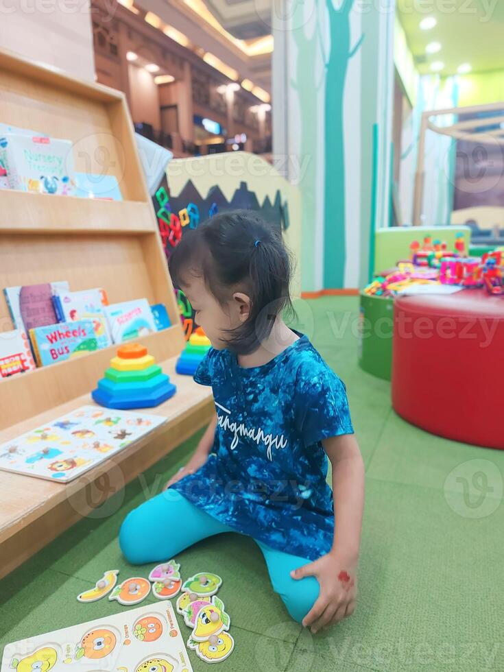 Positive activities for children playing in an indoor area filled with toy facilities and a place where they can find unlimited creativity photo