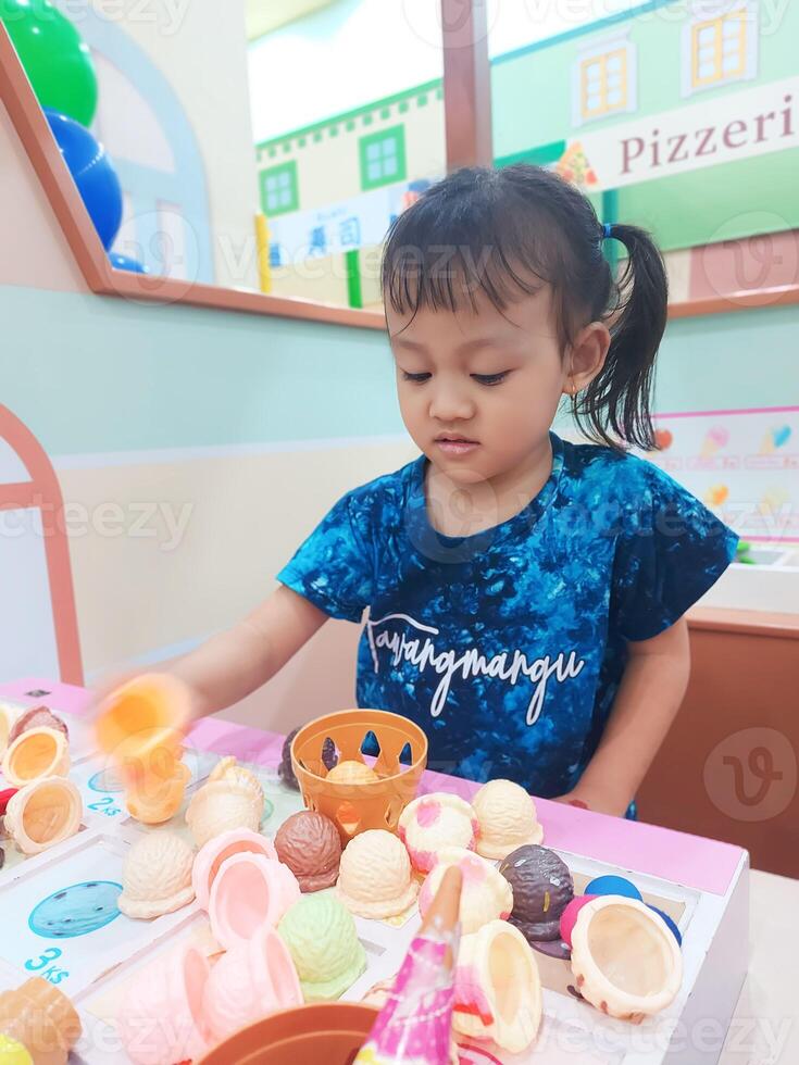 Positive activities for children playing in an indoor area filled with toy facilities and a place where they can find unlimited creativity photo