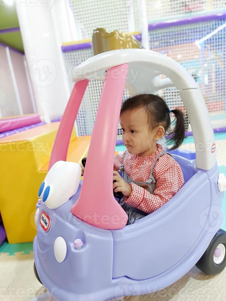Children play in the children's playground in the mall area enjoying the holiday period, doing positive activities and having fun photo