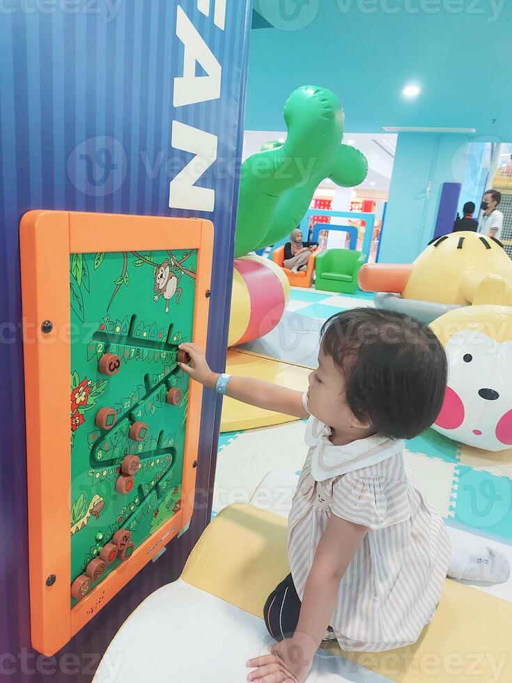 Positive activities for children playing in an indoor area filled with toy facilities and a place where they can find unlimited creativity photo