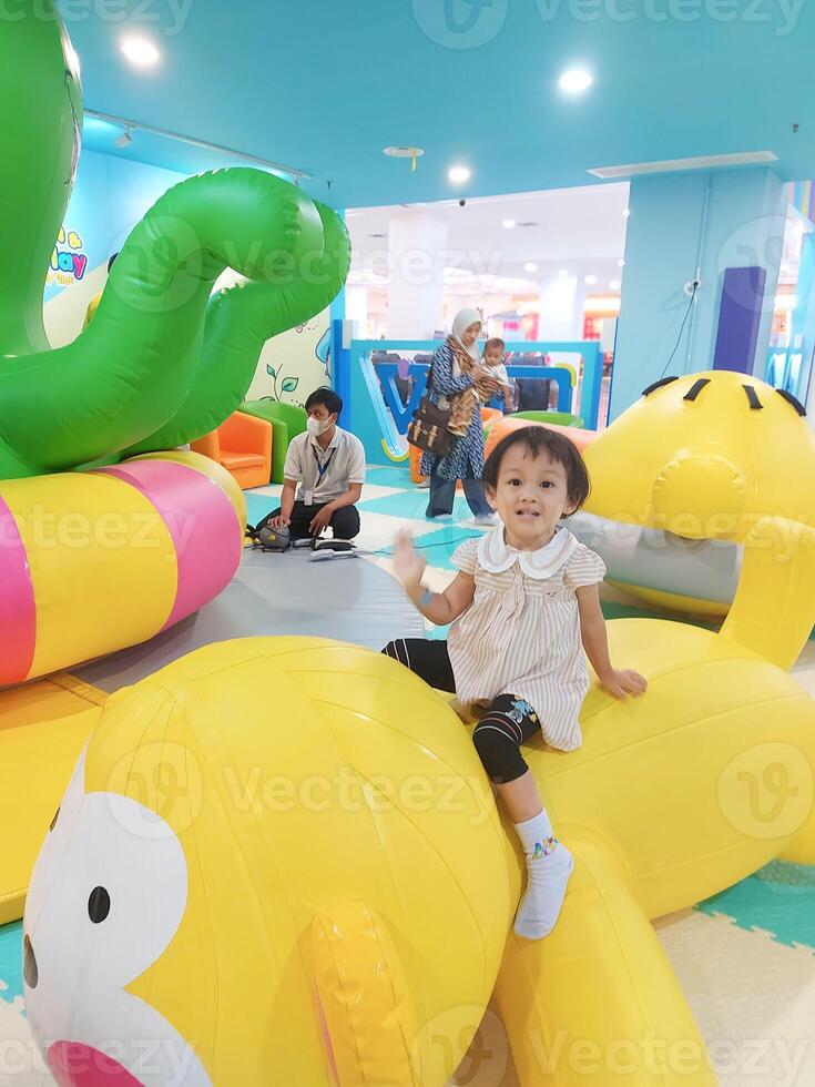 Positive activities for children playing in an indoor area filled with toy facilities and a place where they can find unlimited creativity photo