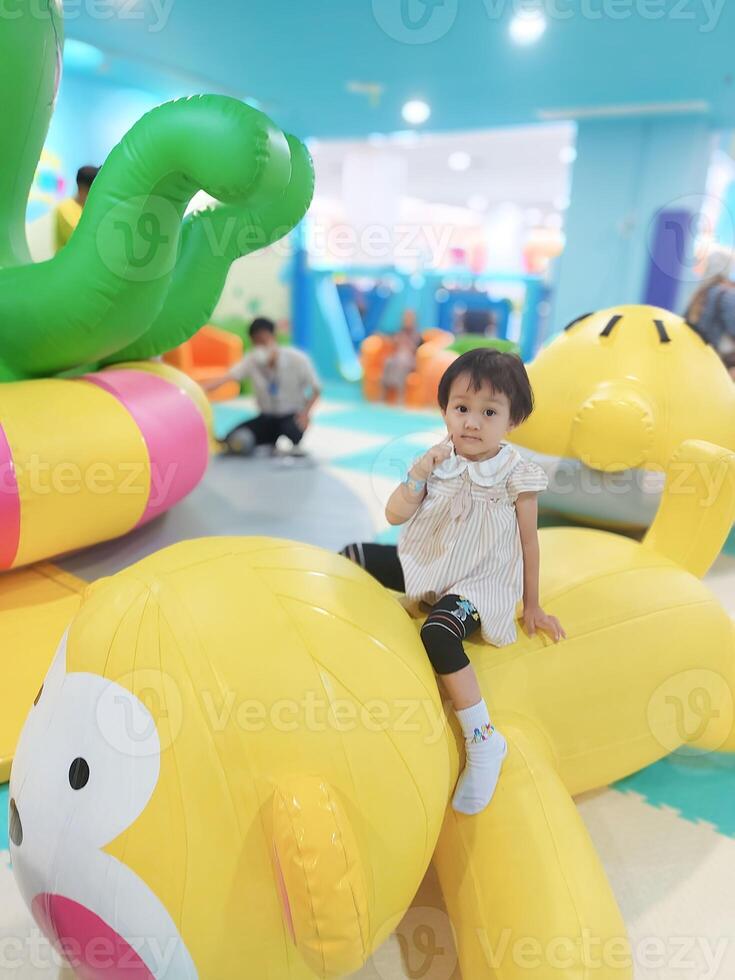 Positive activities for children playing in an indoor area filled with toy facilities and a place where they can find unlimited creativity photo