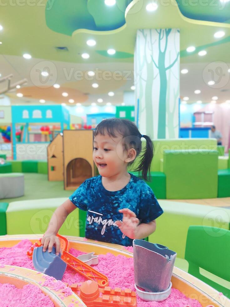 Positive activities for children playing in an indoor area filled with toy facilities and a place where they can find unlimited creativity photo