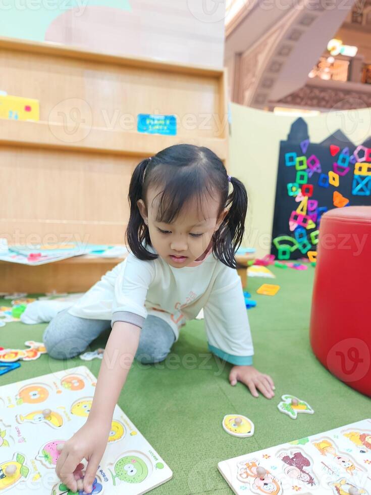 Positive activities for children playing in an indoor area filled with toy facilities and a place where they can find unlimited creativity photo