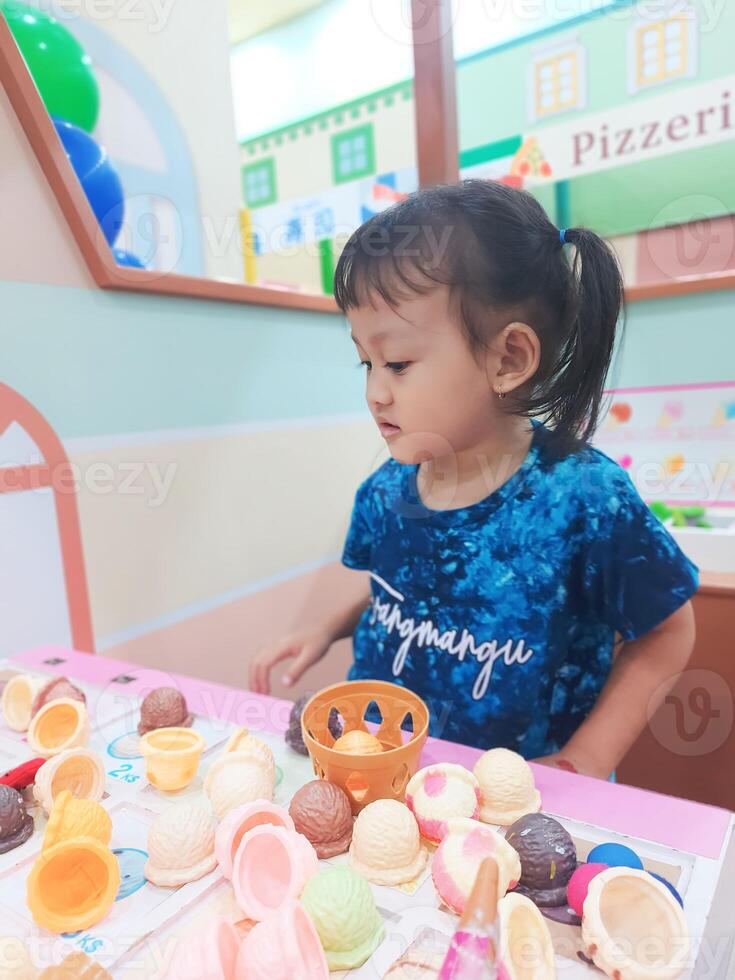 Positive activities for children playing in an indoor area filled with toy facilities and a place where they can find unlimited creativity photo