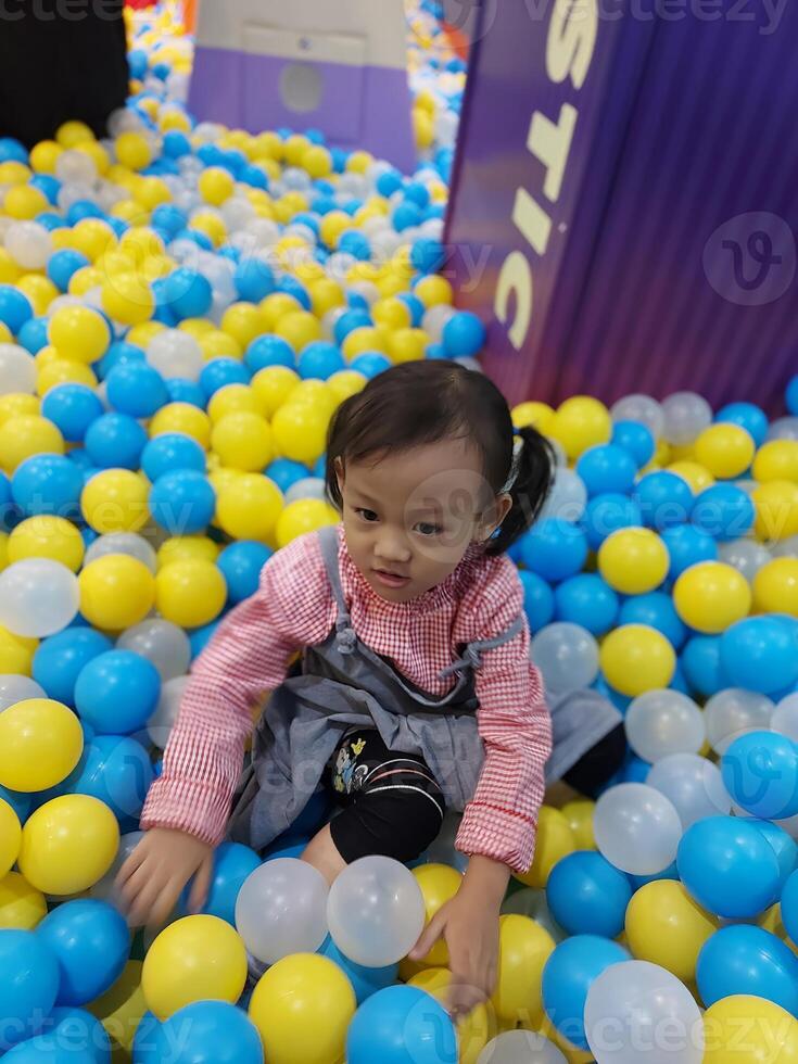Children play in the children's playground in the mall area enjoying the holiday period, doing positive activities and having fun photo