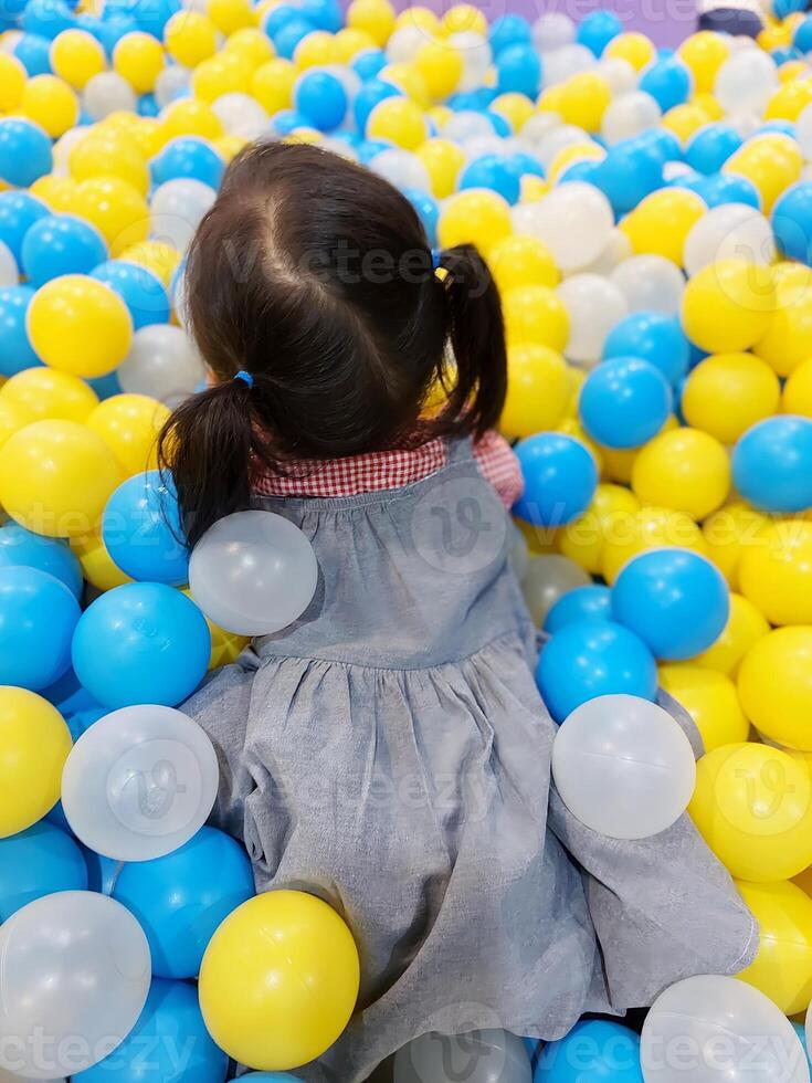 Children play in the children's playground in the mall area enjoying the holiday period, doing positive activities and having fun photo