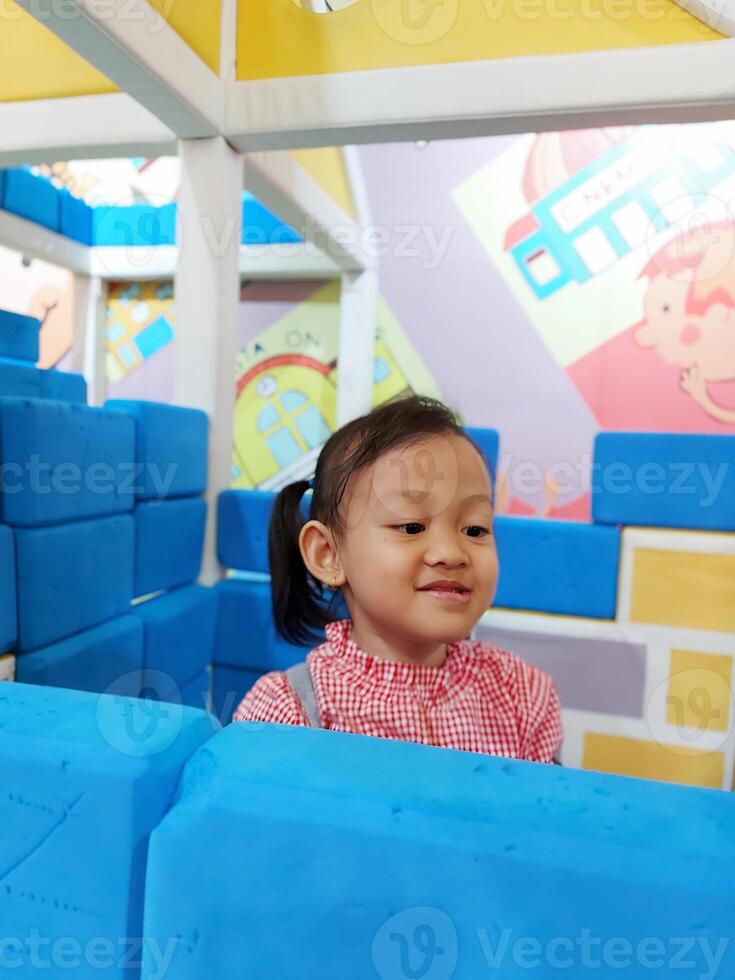 Children play in the children's playground in the mall area enjoying the holiday period, doing positive activities and having fun photo
